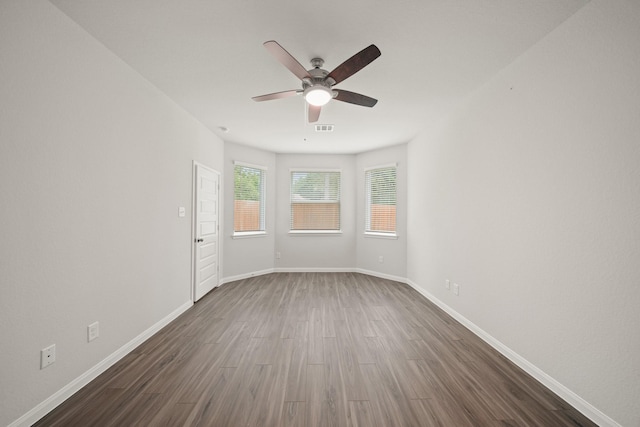 13200 Musky Dr, Conroe, TX 77384 - spare room featuring a ceiling fan and dark wood-type flooring