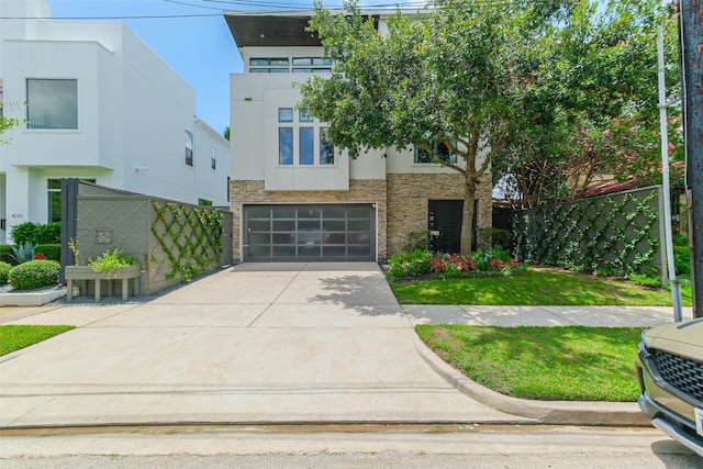 1906 Park St, Houston, TX 77019 - view of front of house featuring stone siding, driveway, a garage, and stucco siding