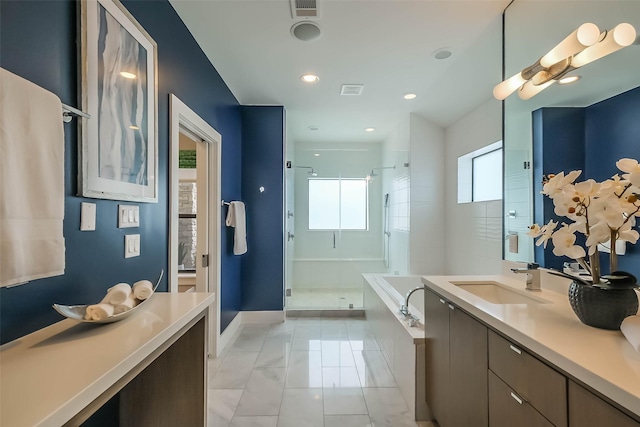 1906 Park St, Houston, TX 77019 - bathroom with a stall shower, a bath, vanity, marble look tiles, and recessed lighting