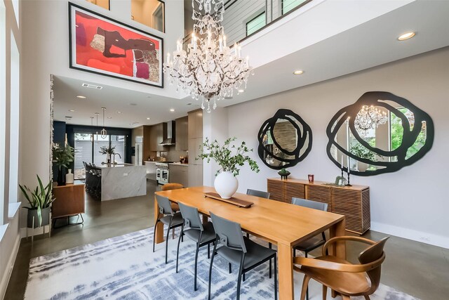 1906 Park St, Houston, TX 77019 - dining room featuring a chandelier, concrete floors, recessed lighting, and a towering ceiling