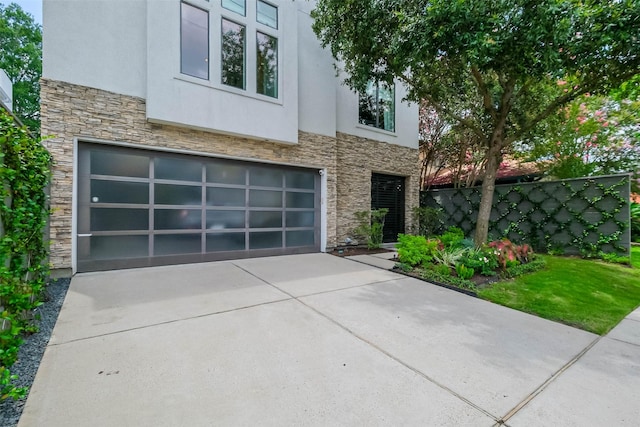 1906 Park St, Houston, TX 77019 - modern home with stone siding, stucco siding, a garage, and driveway