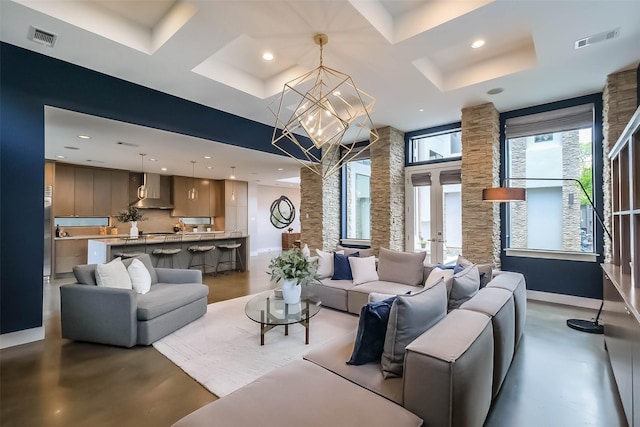 1906 Park St, Houston, TX 77019 - living room featuring a chandelier, recessed lighting, concrete flooring, a tray ceiling, and french doors