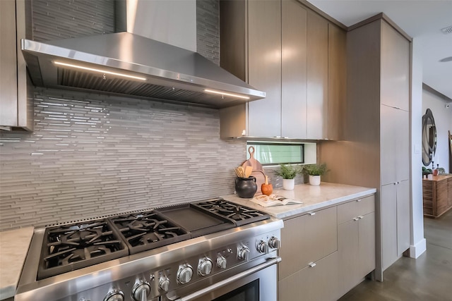 1906 Park St, Houston, TX 77019 - kitchen with high end stainless steel range oven, wall chimney range hood, backsplash, and light countertops