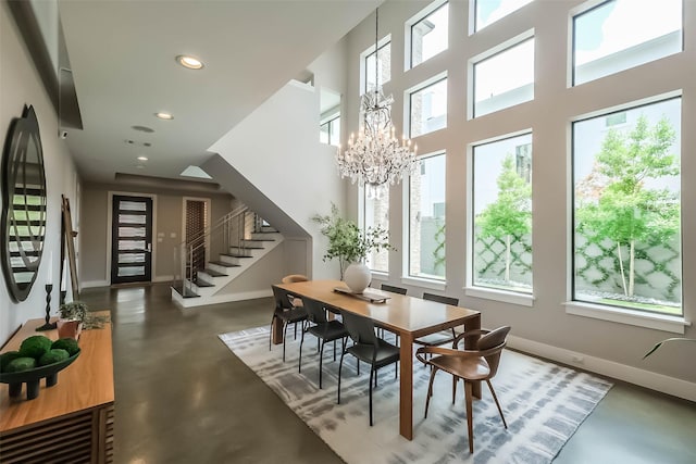 1906 Park St, Houston, TX 77019 - dining room featuring concrete flooring, stairway, plenty of natural light, recessed lighting, and a chandelier