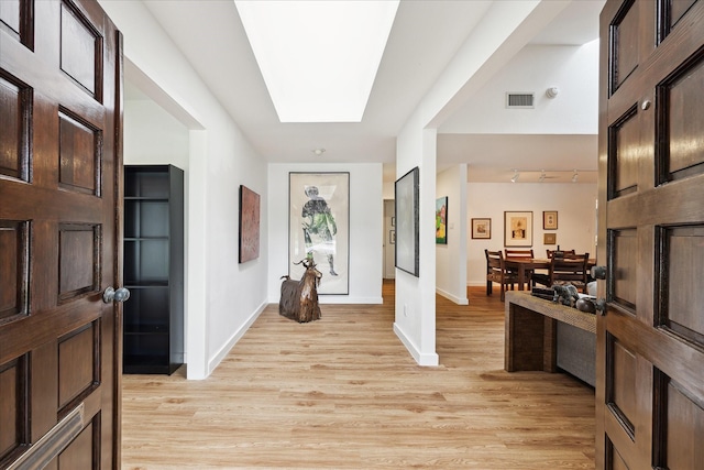 5171 Jason St, Houston, TX 77096 - entrance foyer featuring light wood-style flooring, a skylight, and track lighting