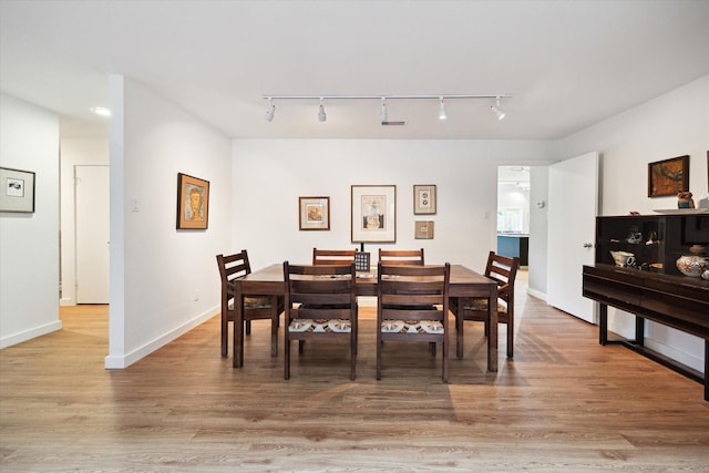 5171 Jason St, Houston, TX 77096 - dining space with rail lighting and light wood-style floors