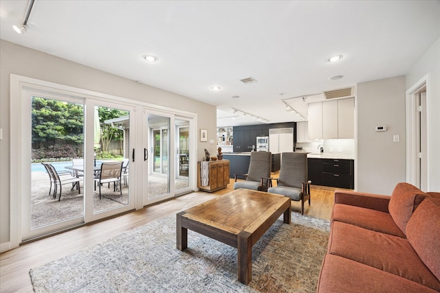 5171 Jason St, Houston, TX 77096 - living area with rail lighting, light wood finished floors, and recessed lighting