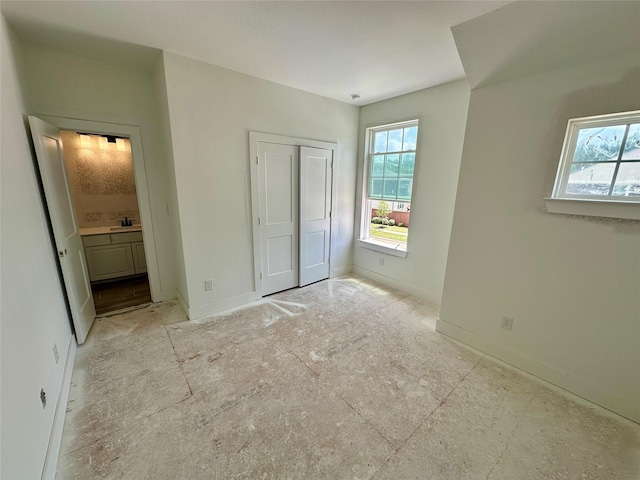 13085 Brookwood Bend Ln, Conroe, TX 77302 - unfurnished bedroom with multiple windows, a closet, and connected bathroom
