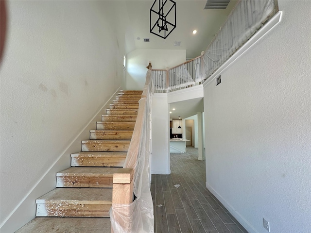13085 Brookwood Bend Ln, Conroe, TX 77302 - staircase with a towering ceiling and wood finished floors