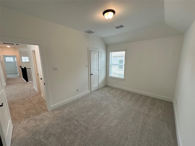 13085 Brookwood Bend Ln, Conroe, TX 77302 - unfurnished bedroom featuring carpet flooring and vaulted ceiling