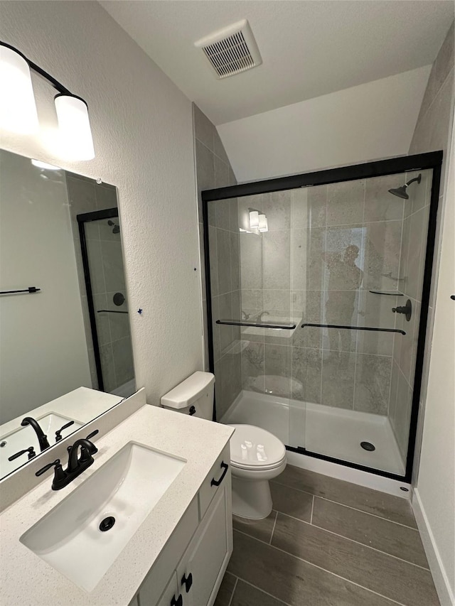 13085 Brookwood Bend Ln, Conroe, TX 77302 - bathroom featuring vanity, a shower stall, vaulted ceiling, and a textured wall