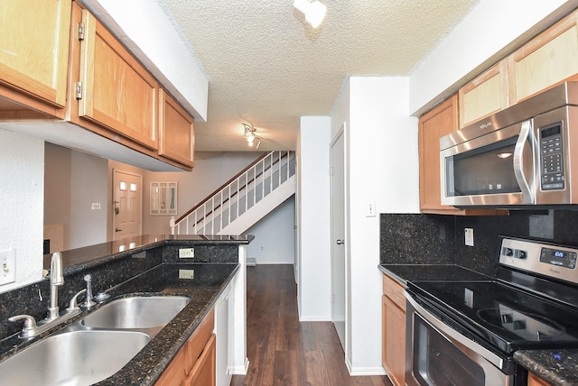 3100 Jeanetta St Unit 1402, Houston, TX 77063 - kitchen with stainless steel appliances, dark wood finished floors, a textured ceiling, dark stone counters, and decorative backsplash