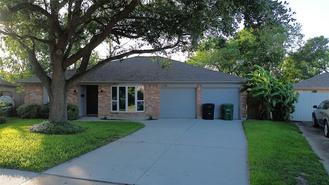 9106 Gustine Ln, Houston, TX 77031 - view of front of house with a garage, a front yard, concrete driveway, brick siding, and roof with shingles