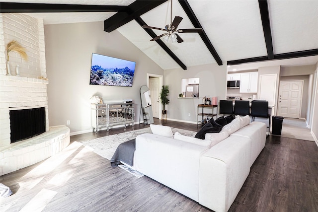 9106 Gustine Ln, Houston, TX 77031 - living area with high vaulted ceiling, dark wood-type flooring, a ceiling fan, beam ceiling, and a brick fireplace