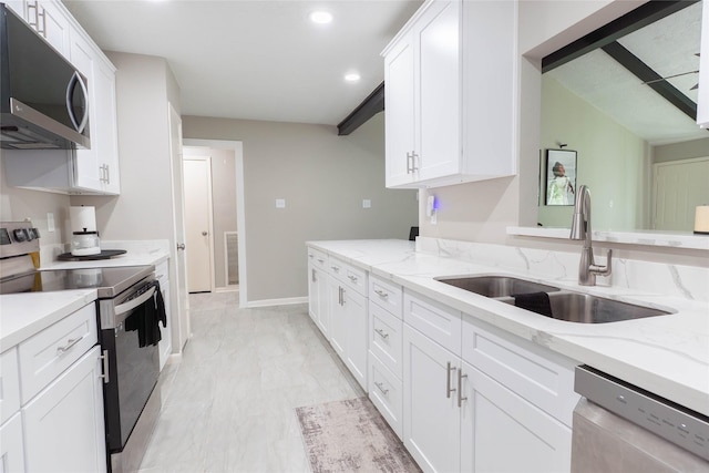 9106 Gustine Ln, Houston, TX 77031 - kitchen with appliances with stainless steel finishes, light marble finish flooring, white cabinetry, recessed lighting, and light stone countertops