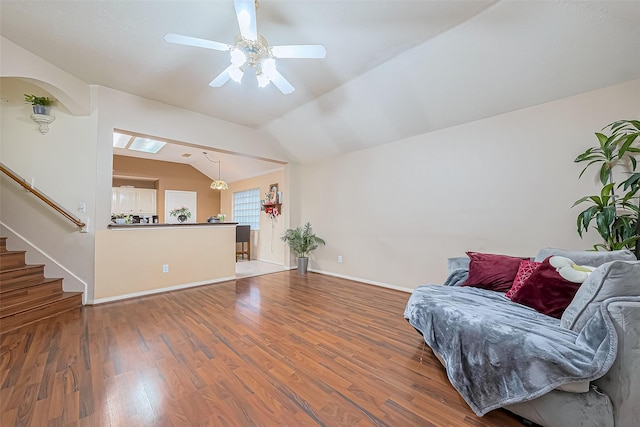 10323 Emerald Pine Dr, Houston, TX 77070 - living area with a ceiling fan, wood finished floors, stairs, vaulted ceiling, and arched walkways