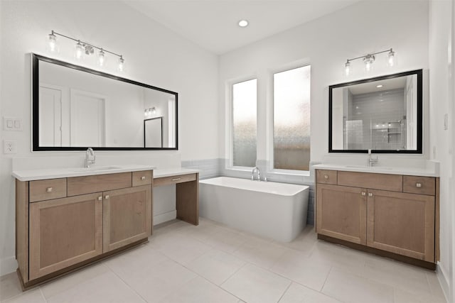 12814 Forest Garden Ct, Conroe, TX 77302 - full bathroom with tile patterned flooring, tiled shower, a soaking tub, and two vanities