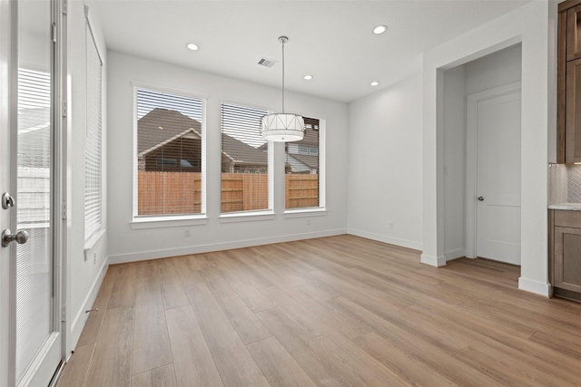 12814 Forest Garden Ct, Conroe, TX 77302 - unfurnished dining area with light wood-style flooring and recessed lighting