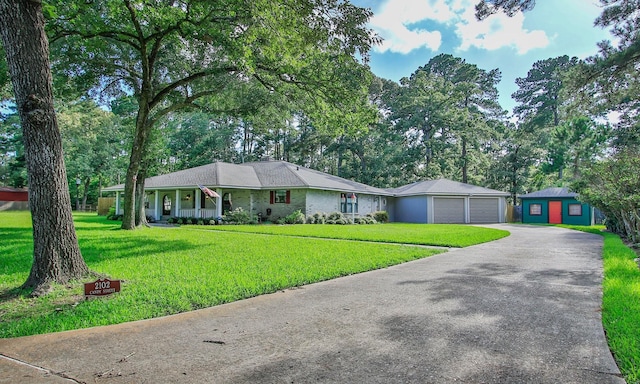 2102 Candy St, Pinehurst, TX 77362 - ranch-style house featuring an attached garage, an outdoor structure, driveway, and a front yard