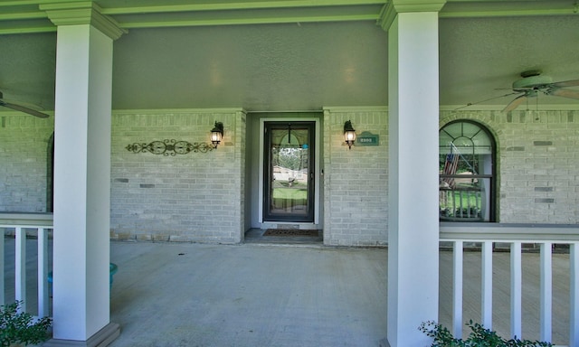 2102 Candy St, Pinehurst, TX 77362 - doorway to property with a porch, ceiling fan, and brick siding