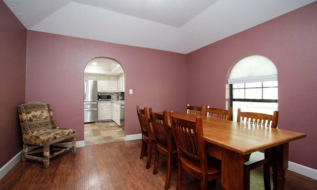 2102 Candy St, Pinehurst, TX 77362 - dining area featuring wood finished floors and arched walkways