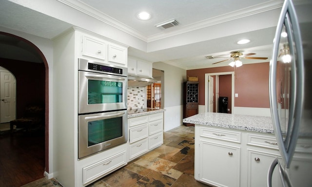 2102 Candy St, Pinehurst, TX 77362 - kitchen with stainless steel appliances, stone tile flooring, crown molding, under cabinet range hood, and recessed lighting