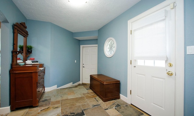 2102 Candy St, Pinehurst, TX 77362 - foyer entrance with light stone finish floors and a textured ceiling