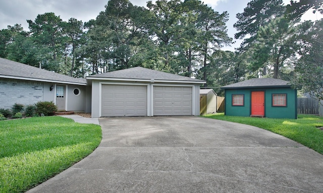 2102 Candy St, Pinehurst, TX 77362 - view of front of home with a front yard, a detached garage, an outbuilding, and stucco siding