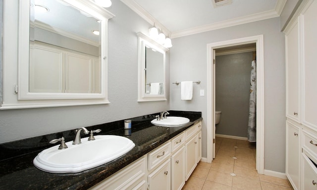 2102 Candy St, Pinehurst, TX 77362 - bathroom featuring double vanity, tile patterned flooring, and ornamental molding