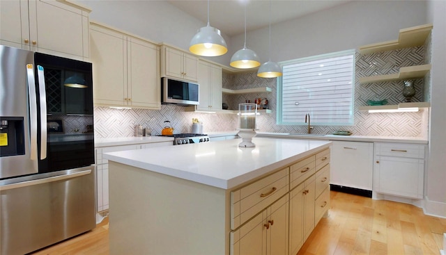 2611 Sherwin St, Houston, TX 77007 - kitchen with stainless steel appliances, open shelves, light wood-style flooring, decorative backsplash, and light countertops
