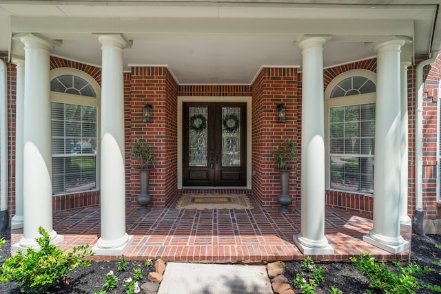3007 Mullingar Walk, Missouri City, TX 77459 - doorway to property featuring french doors, brick siding, and a porch
