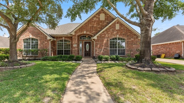 9138 Shango Ln, Houston, TX 77095 - view of front of property featuring a front yard and brick siding