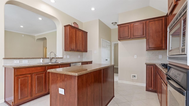 9138 Shango Ln, Houston, TX 77095 - kitchen with stainless steel appliances, arched walkways, backsplash, a kitchen island, and light stone counters