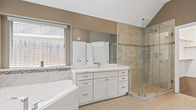 9138 Shango Ln, Houston, TX 77095 - full bathroom featuring a stall shower, a garden tub, vanity, tile patterned floors, and lofted ceiling