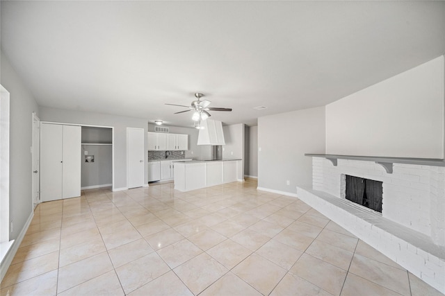 4406 Kacee Dr, Houston, TX 77084 - unfurnished living room featuring light tile patterned flooring, a ceiling fan, and a brick fireplace