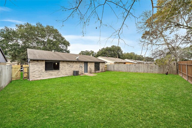 4406 Kacee Dr, Houston, TX 77084 - back of property with brick siding, a fenced backyard, and roof with shingles
