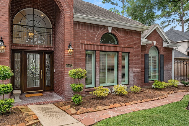 12927 Finch Brook Dr, Cypress, TX 77429 - view of exterior entry with brick siding and a shingled roof