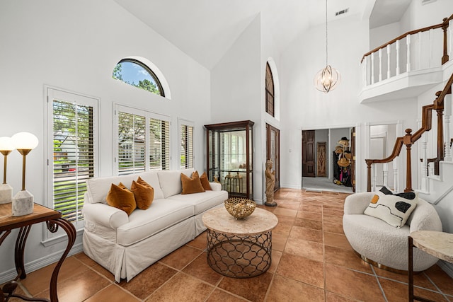 12927 Finch Brook Dr, Cypress, TX 77429 - living area with high vaulted ceiling, a chandelier, and stairs