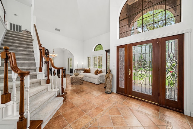 12927 Finch Brook Dr, Cypress, TX 77429 - entrance foyer with a high ceiling, arched walkways, healthy amount of natural light, and stairway