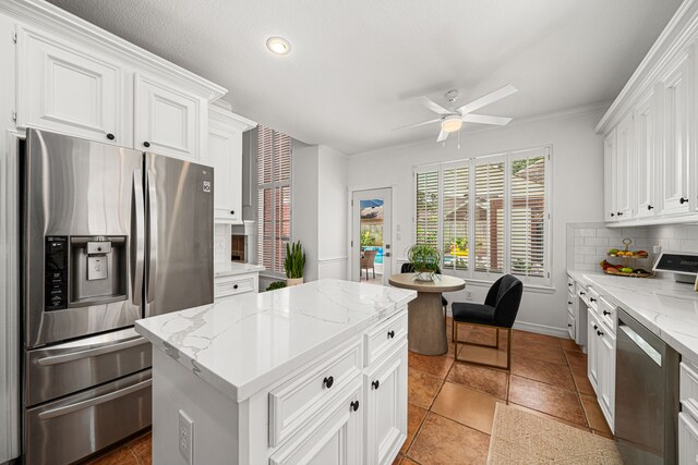 12927 Finch Brook Dr, Cypress, TX 77429 - kitchen with stainless steel appliances, tasteful backsplash, ceiling fan, white cabinetry, and recessed lighting