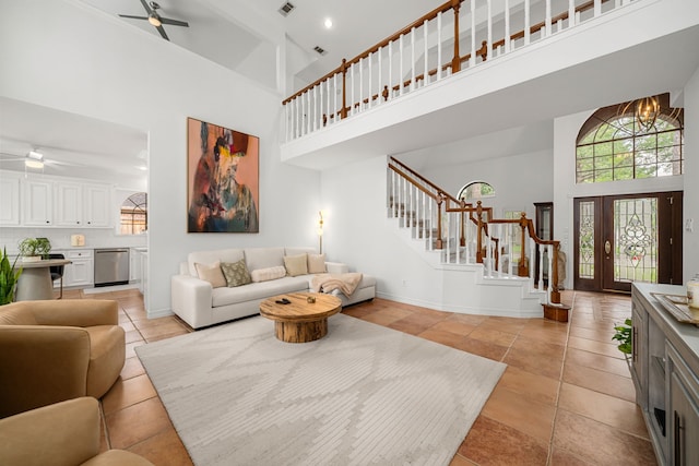 12927 Finch Brook Dr, Cypress, TX 77429 - living room with a towering ceiling, a ceiling fan, stairway, light tile patterned floors, and a chandelier