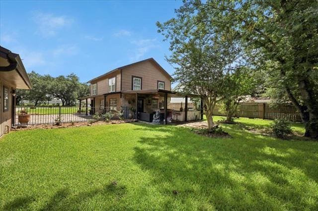3231 Charles Ave, Groves, TX 77619 - rear view of house featuring a fenced backyard and stone siding