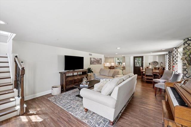 3231 Charles Ave, Groves, TX 77619 - living room with wood finished floors, stairway, and recessed lighting