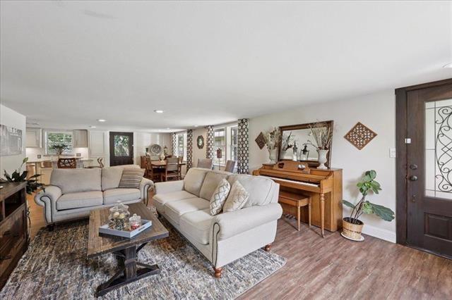 3231 Charles Ave, Groves, TX 77619 - living area featuring plenty of natural light, wood finished floors, and recessed lighting