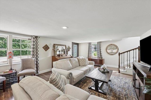 3231 Charles Ave, Groves, TX 77619 - living area featuring stairs, wood finished floors, and recessed lighting