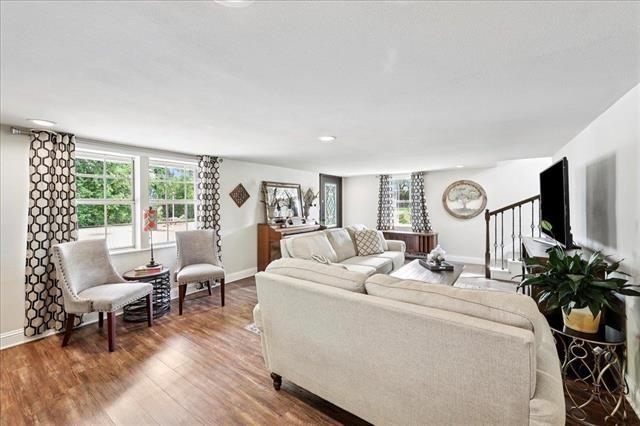 3231 Charles Ave, Groves, TX 77619 - living room featuring baseboards and wood finished floors