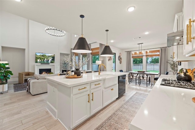19011 Festival Hill Ct, Cypress, TX 77433 - kitchen featuring black dishwasher, white cabinets, light wood-style flooring, plenty of natural light, and recessed lighting