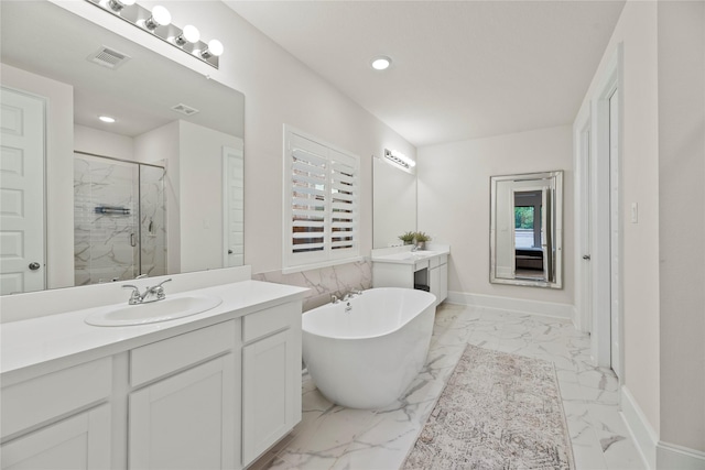19011 Festival Hill Ct, Cypress, TX 77433 - bathroom featuring a marble finish shower, two vanities, marble finish floors, a freestanding bath, and recessed lighting