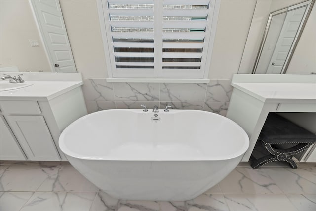 19011 Festival Hill Ct, Cypress, TX 77433 - bathroom with marble look tile flooring, vanity, and a freestanding tub