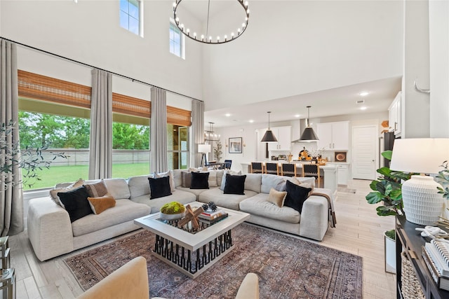 19011 Festival Hill Ct, Cypress, TX 77433 - living area with a chandelier, light wood-style flooring, a high ceiling, and recessed lighting